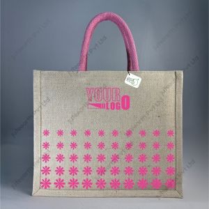 Custom printed JuCo (jute cotton) bag with pink daisy petal print and pink rope handles, front view with sample logo