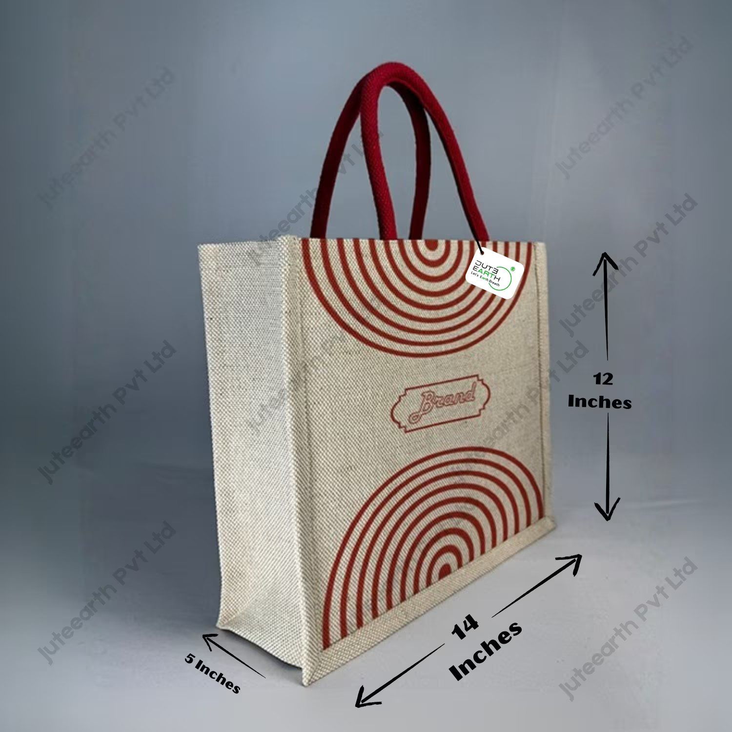 Custom printed JuCo (jute cotton) bag with red semi-concentric print and red rope handles, angled view with dimensions 12 x 14 x 5 inches