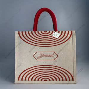Custom printed JuCo (jute cotton) bag with red semi-concentric print and red rope handles, front view with sample logo