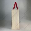 Custom printed JuCo (jute cotton) bag with red semi-concentric print and red rope handles, side view showing the gusset