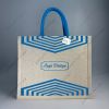 Custom printed JuCo (jute cotton) bag with blue V-strip print and blue rope handles, front view with sample logo