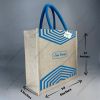 Custom printed JuCo (jute cotton) bag with blue V-strip print and blue rope handles, angled view with dimensions 12 x 14 x 5 inches