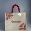 Custom printed JuCo (jute cotton) bag with red concentric quarter-circle print and red rope handles, front view with sample logo