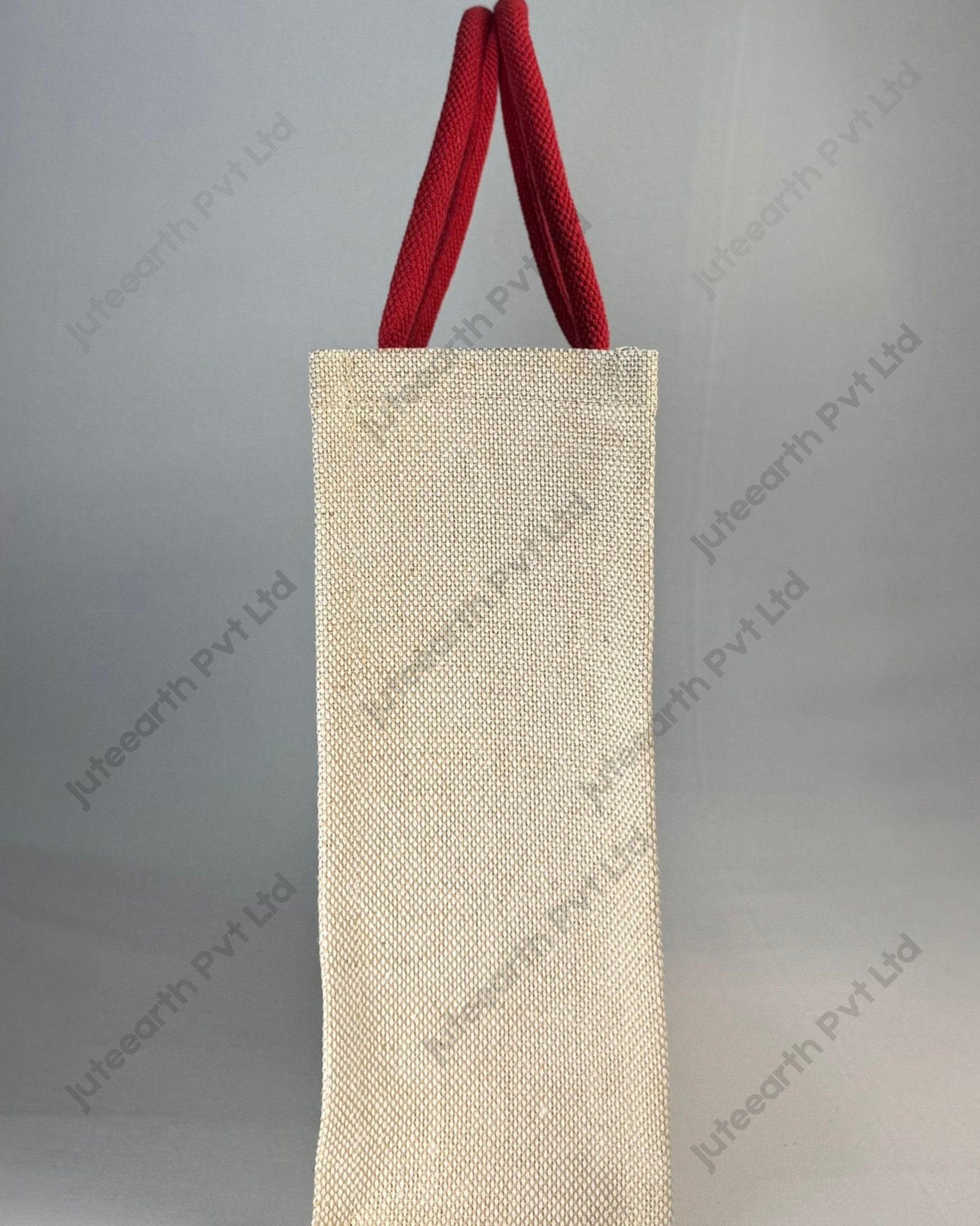 Custom printed JuCo (jute cotton) bag with red concentric quarter-circle print and red rope handles, side view showing the gusset
