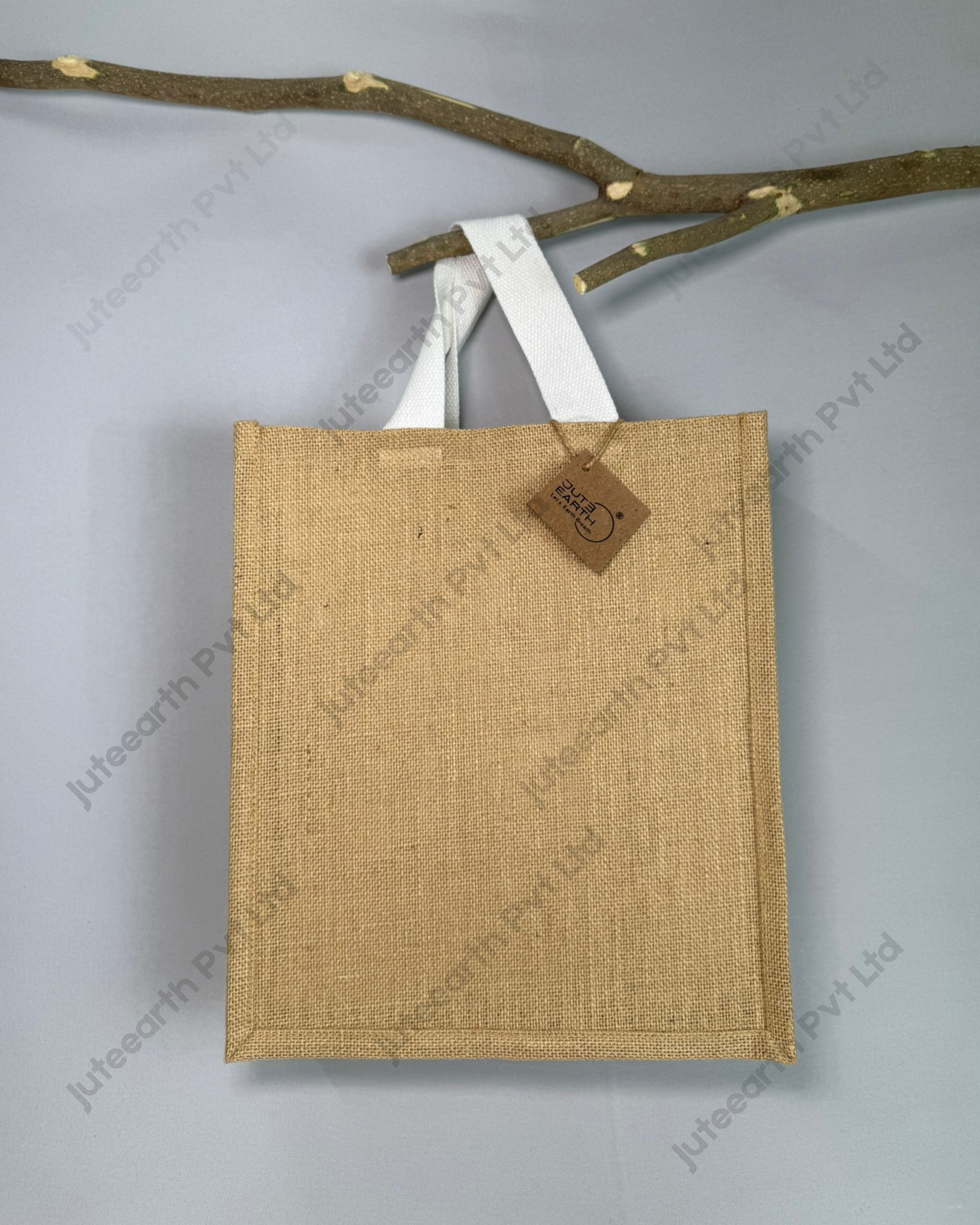 Plain natural jute bag with starch finish and white cotton handles, narrow shape, front view